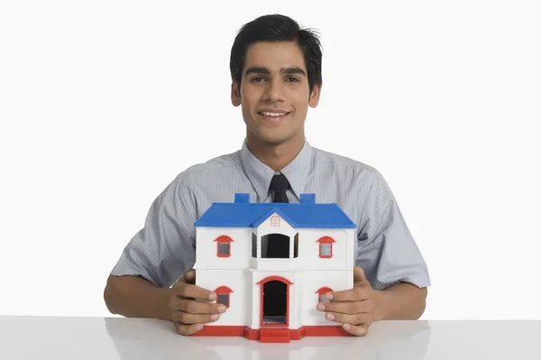 Real estate agent holding a model home — Stock Photo, Image