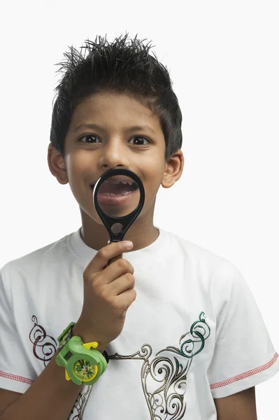 Boy holding a magnifying glass — Stock Photo, Image