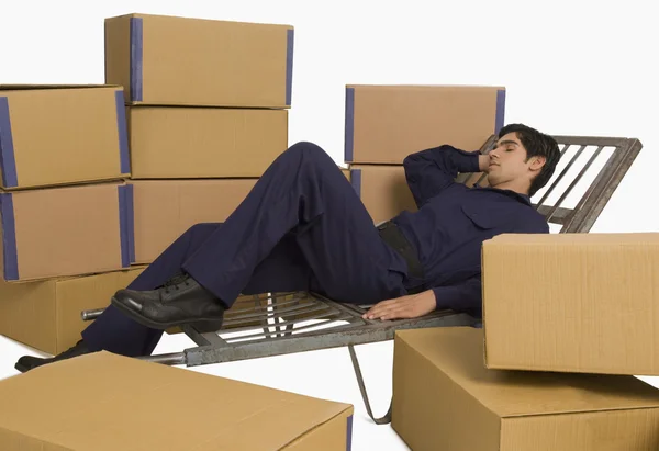 Storekeeper sleeping on a hand truck — Stock Photo, Image