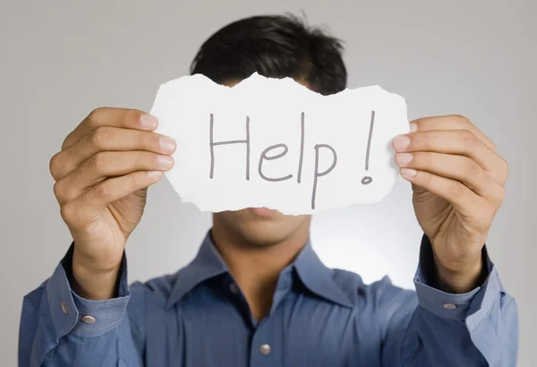 Man holding a paper with help word — Stock Photo, Image