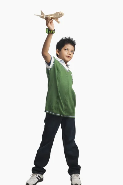 Boy playing with a toy airplane — Stock Photo, Image