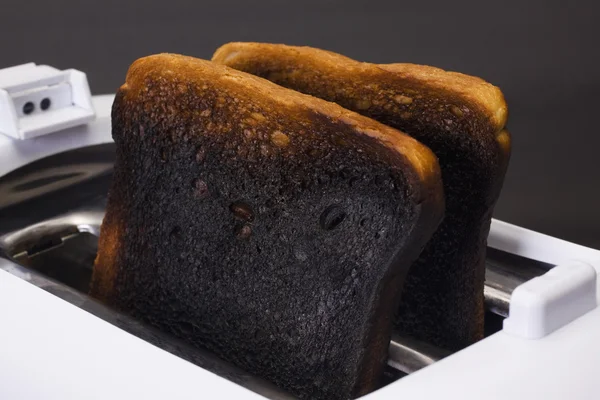 Burnt toasts in a toaster — Stock Photo, Image