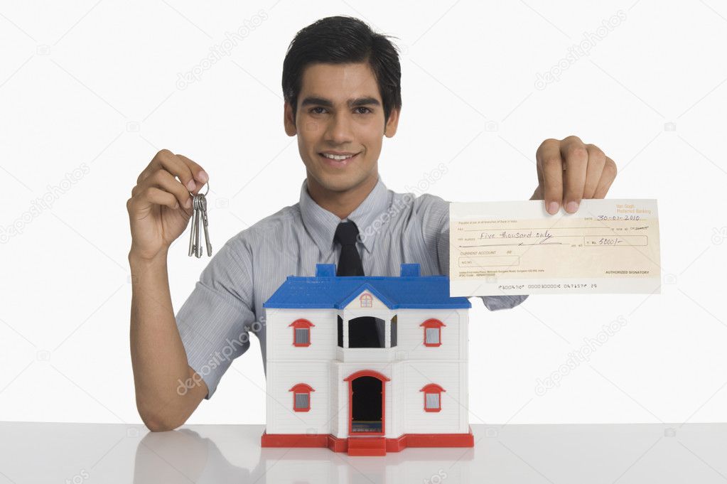 Real estate agent showing keys and a check — Stock Photo © imagedb