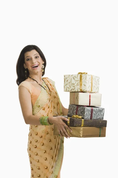 Surprised woman holding gifts at Diwali festival — Stock Photo, Image