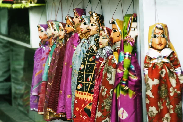 Wooden puppets hanging at a market stall — Stock Photo, Image