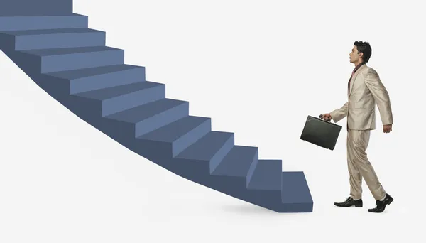 Businessman moving up staircase — Stock Photo, Image