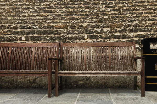 Benches in front of a weathered wall — Stock Photo, Image