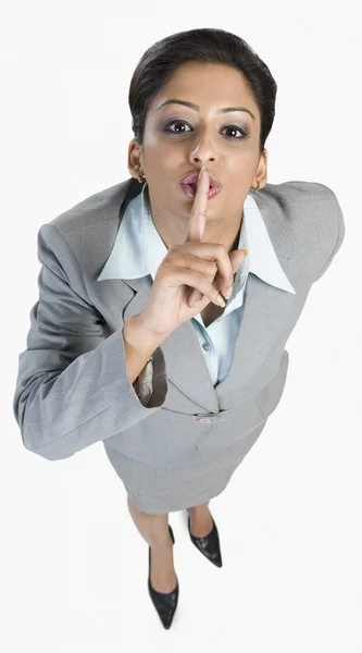 Businesswoman with her finger on her lips — Stock Photo, Image