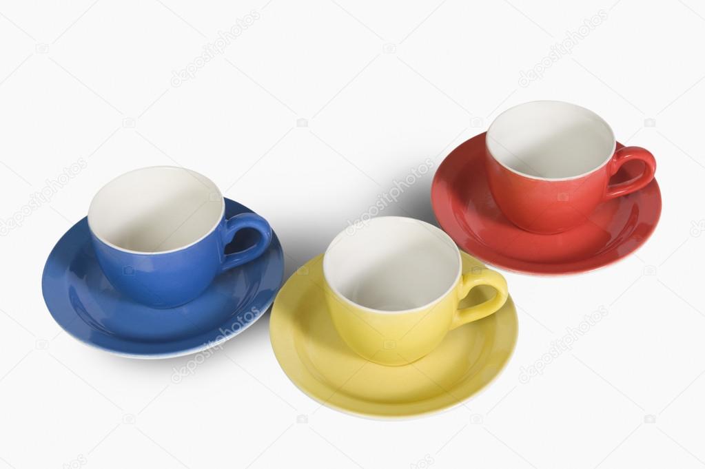 Colorful tea cups with saucers