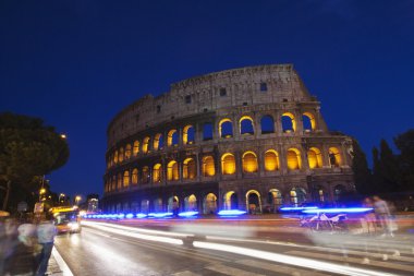 Night traffic in front of Colosseum clipart