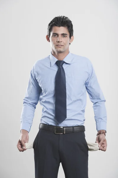 Businessman showing his empty pockets — Stock Photo, Image