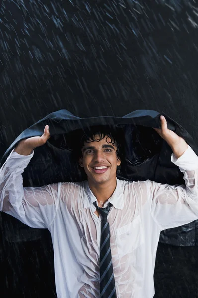 Businessman enjoying in the rain — Stock Photo, Image