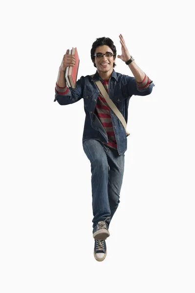 Student running with books and bag — Stock Photo, Image