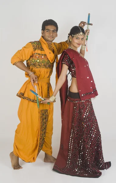 Couple performing dandiya — Stock Photo, Image