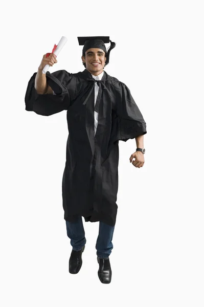 Male graduate cheering with his diploma — Stock Photo, Image