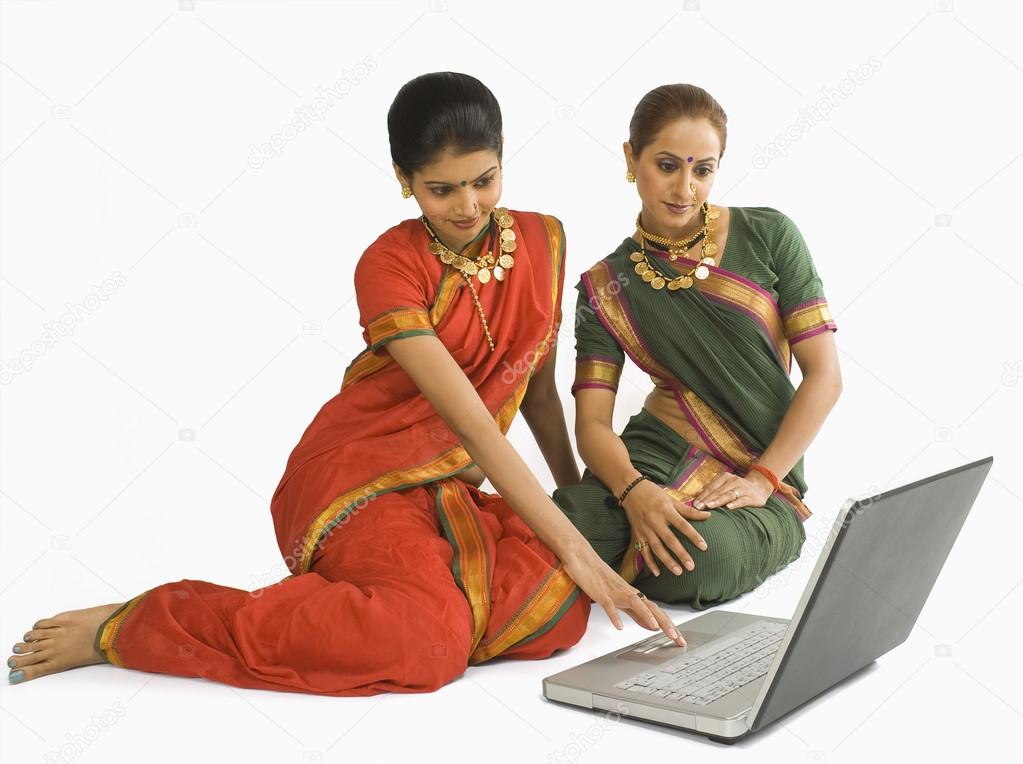 Woman using a laptop with her friend