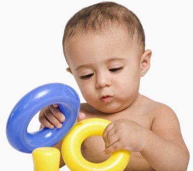 Baby boy playing with toys clipart