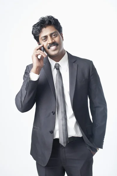 Businessman talking on a mobile phone — Stock Photo, Image