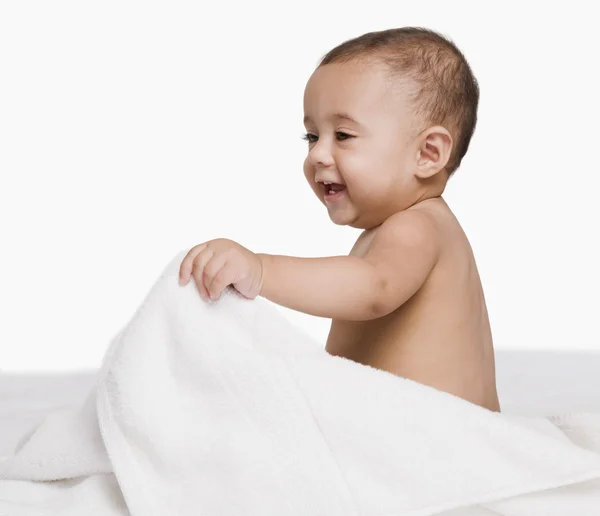 Baby boy playing with a towel — Stock Photo, Image