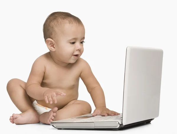 Baby boy using a laptop — Stock Photo, Image