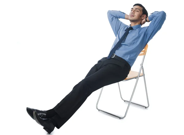 Bengali businessman reclining on a chair — Stock Photo, Image