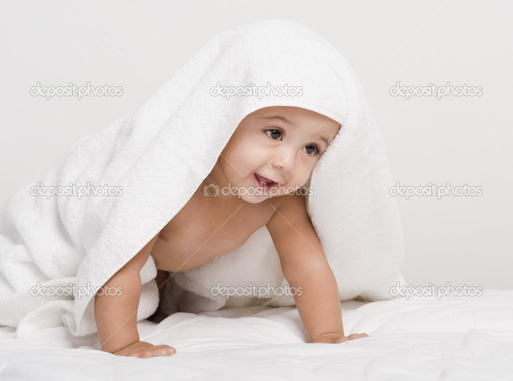 Baby boy playing with a towel