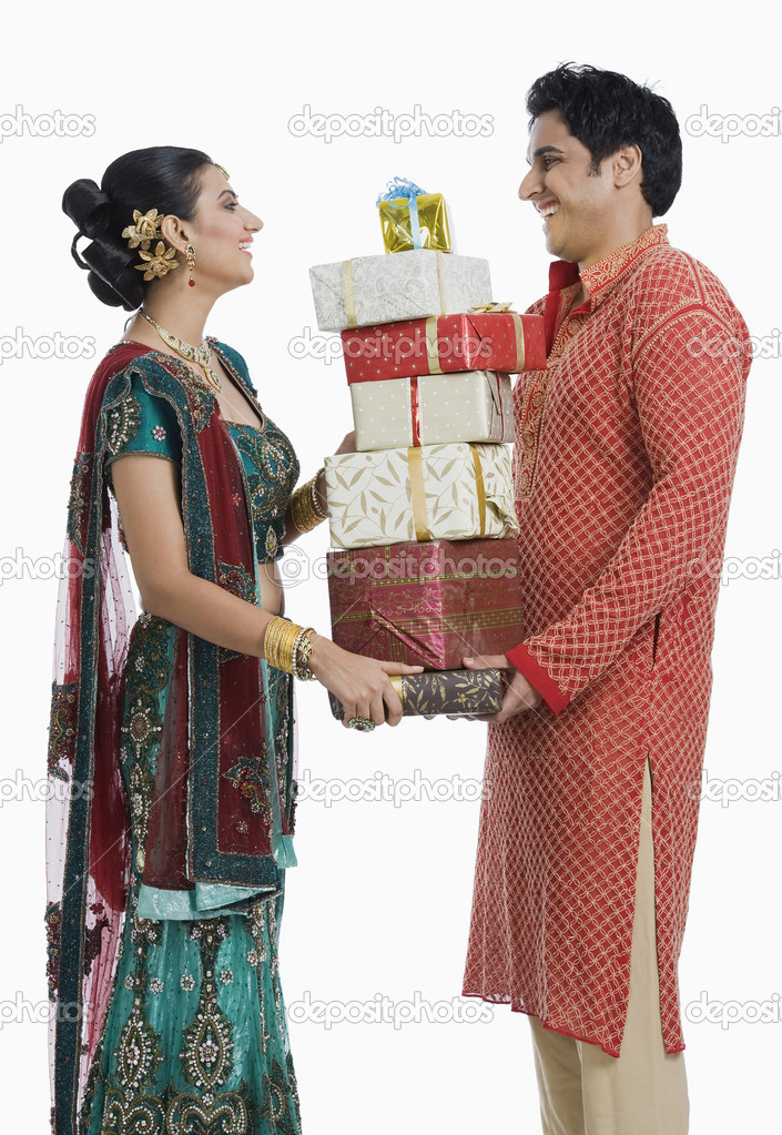 Couple holding gifts on Diwali