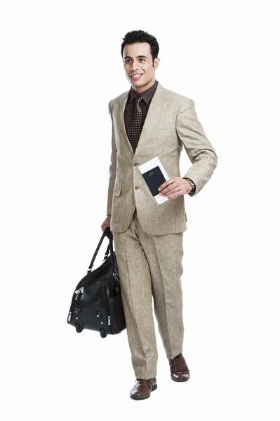 Businessman with holding passport and luggage bag — Stock Photo, Image