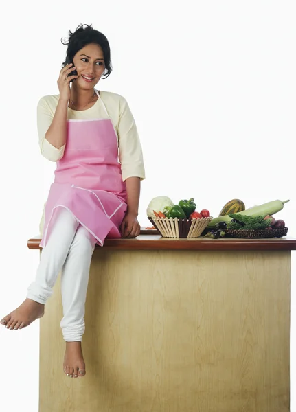 Woman sitting near vegetables — Stock Photo, Image