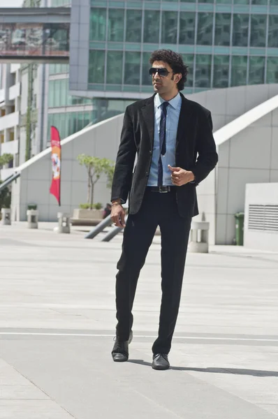 Businessman standing in front of an office building — Stock Photo, Image