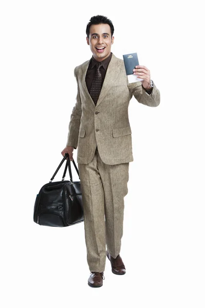 Businessman holding passport and luggage bag — Stock Photo, Image