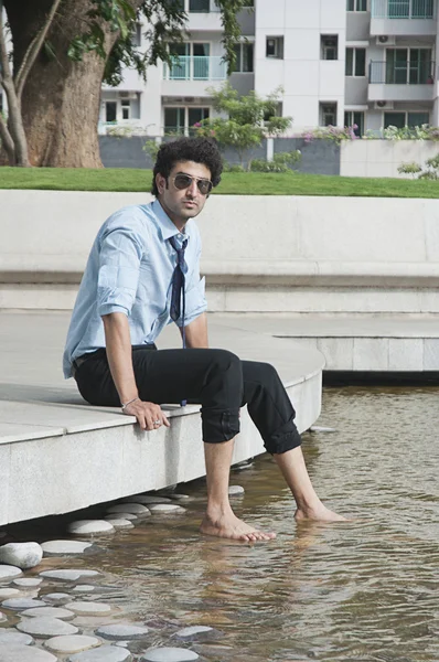 Businessman thinking at poolside — Stock Photo, Image