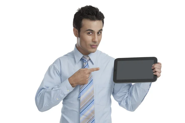 Businessman pointing towards a digital tablet — Stock Photo, Image