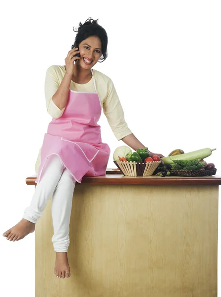 Woman sitting near vegetables — Stock Photo, Image