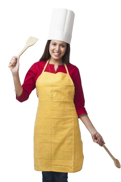 Woman holding a spatula and ladle — Stock Photo, Image