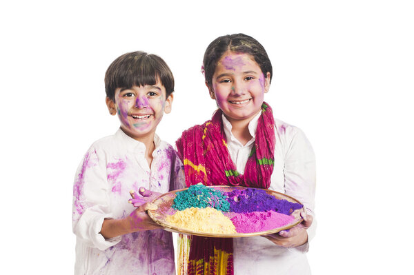 Brother and sister celebrating Holi festival