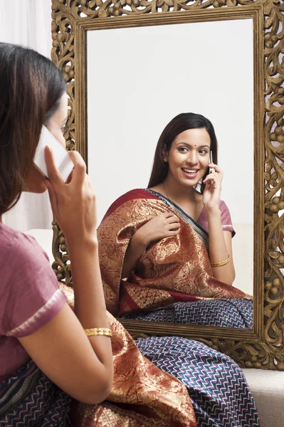 Reflection of a woman in mirror — Stock Photo, Image