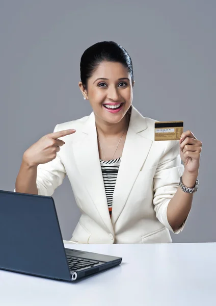 Femme d'affaires pointant vers une carte de crédit — Photo