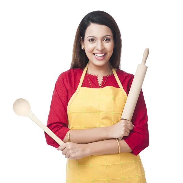 Woman holding a rolling pin and ladle — Stock Photo, Image