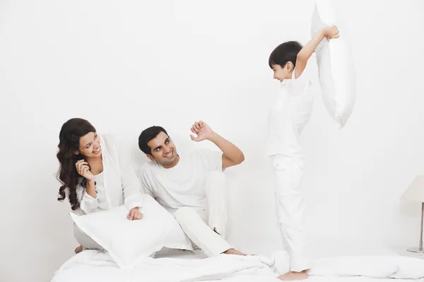 Boy pillow fight with his parents — Stock Photo, Image