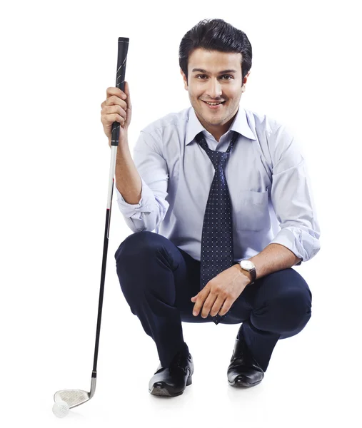 Businessman holding a golf club — Stock Photo, Image