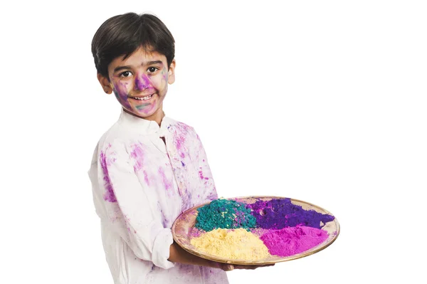Boy holding Holi colors in a plate — Zdjęcie stockowe
