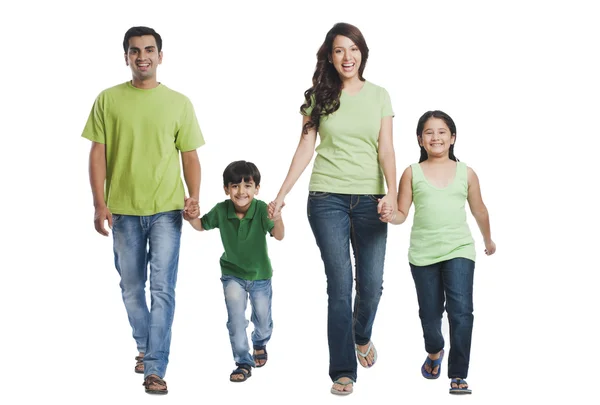 Happy family holding hands and walking — Stock Photo, Image