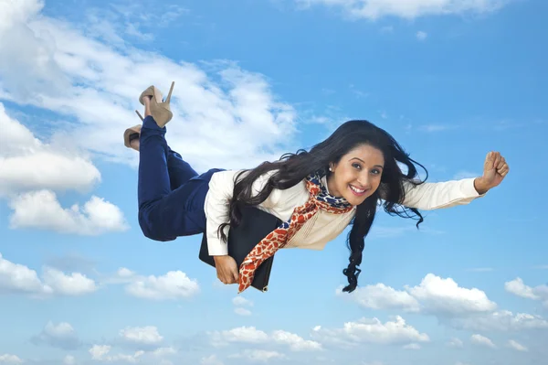 Businesswoman flying with a laptop — Stock Photo, Image