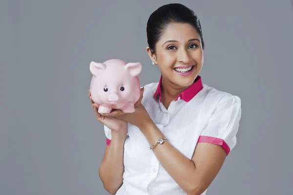 Woman holding a piggy bank — Stock Photo, Image