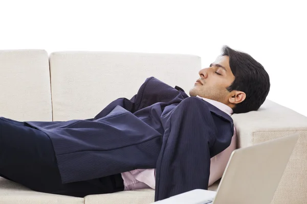 Businessman resting on a couch — Stock Photo, Image