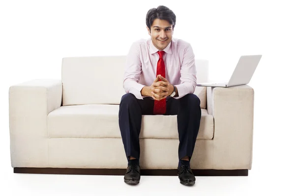 Businessman sitting on a couch — Stock Photo, Image