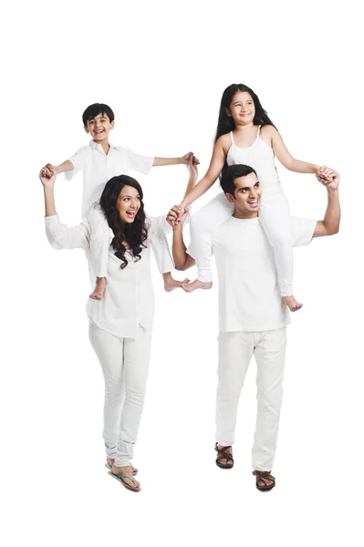 Parents carrying their children on shoulders — Stock Photo, Image