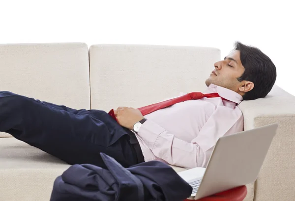 Businessman resting on a couch — Stock Photo, Image