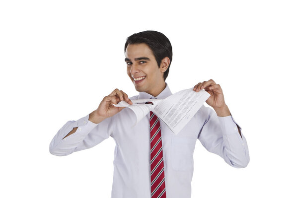 Businessman tearing a paper